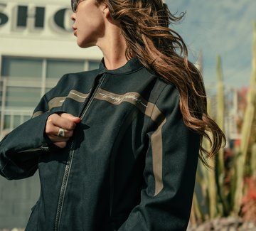 woman in jacket putting on helmet