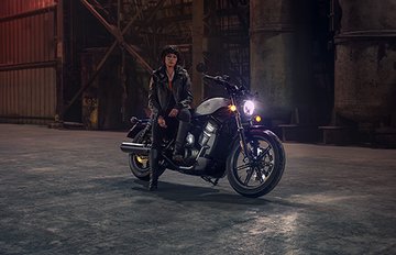women sitting on motorcycle